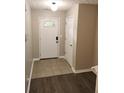 Open entryway featuring neutral-colored walls, tiled flooring, and doors leading to other rooms in the home at 3336 Waldrop Trl, Decatur, GA 30034