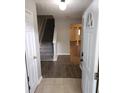 Inviting entryway with tiled floor transitioning to wood flooring and a staircase leading to the upper level at 3336 Waldrop Trl, Decatur, GA 30034