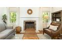 Cozy living room featuring a fireplace with decorative screen, comfortable seating, and natural light at 4175 Valley Trail Se Dr, Atlanta, GA 30339