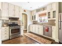 Well-lit kitchen with stainless steel appliances, hardwood floors, and plenty of cabinet space at 2029 Tuxedo Ne Ave, Atlanta, GA 30307