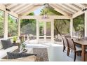 Inviting screened porch with comfortable seating, ceiling fan, and views of the backyard at 2029 Tuxedo Ne Ave, Atlanta, GA 30307