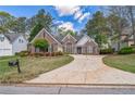 Beautiful brick home showcasing a well-maintained front yard and a long driveway at 2602 White Aster Ln, Dacula, GA 30019