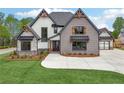 Charming two-story home with stone and siding, complemented by a well-manicured lawn and fresh landscaping at 1095 Lanier Pl, Cumming, GA 30041