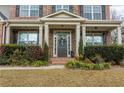 Inviting front porch featuring a decorative wreath, brick steps, and manicured landscaping at 3945 Starwood Dr, Cumming, GA 30028
