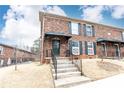 Brick townhome featuring dark shutters and trim, showcasing a classic and inviting facade at 5672 Kingsport Dr # 4, Atlanta, GA 30342