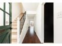 Inviting foyer featuring hardwood floors, stairs with iron railing and access to other rooms at 5672 Kingsport Dr # 4, Atlanta, GA 30342