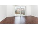 Bright living room featuring sliding glass door and wood floors overlooking outdoor patio at 5672 Kingsport Dr # 4, Atlanta, GA 30342