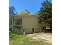 Side of home showing a garage, door, porch, and forested backyard at 1905 Rockmart Rd, Villa Rica, GA 30180