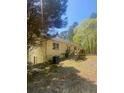 View of the home's backyard with steps leading up to the double doors and yard at 1905 Rockmart Rd, Villa Rica, GA 30180