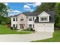 Charming two-story home featuring a lush green lawn, brick facade, and attached two-car garage at 160 Fieldstone Dr, Powder Springs, GA 30127