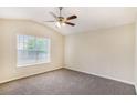 Spacious bedroom with neutral carpet, vaulted ceiling, ceiling fan, and large window offering plenty of natural light at 175 Regency Park Dr, Mcdonough, GA 30253