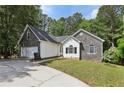 Attractive one-story home featuring stone accents, well-manicured lawn and a wide driveway at 1945 Grayson Oaks Ct, Lawrenceville, GA 30045
