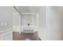 Elegant foyer featuring hardwood floors, white trim, and a decorative mirror at 248 Colony Center Dr, Woodstock, GA 30188