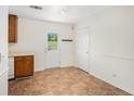 Bright kitchen area with tile floor, a view to the backyard, and white trim at 5794 Parks Rd, Cumming, GA 30041