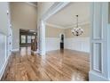 Elegant dining room with hardwood floors, wainscoting, and a stylish chandelier, perfect for entertaining guests at 631 Mabry Rd, Sandy Springs, GA 30328