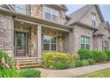 Charming stone front porch with large columns and manicured landscaping adding to the home's curb appeal at 631 Mabry Rd, Sandy Springs, GA 30328