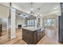 Open-concept kitchen featuring a large island, granite countertops, and seamlessly flowing into the living space at 631 Mabry Rd, Sandy Springs, GA 30328