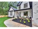 Inviting exterior with covered porch, stylish seating, professional landscaping, and lush lawn at 801 Braselton Hwy, Lawrenceville, GA 30043