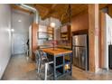Compact kitchen area with stainless steel appliances, butcher block island, and stylish mosaic tile backsplash at 170 Boulevard Se # H405, Atlanta, GA 30312