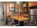 Updated kitchen showcasing mosaic backsplash, stainless appliances, and a charming butcher block island with seating at 170 Boulevard Se # H405, Atlanta, GA 30312