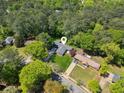 Aerial view of a home nestled amongst lush trees in a well-developed suburban neighborhood at 553 Candlewood Dr, Stone Mountain, GA 30088