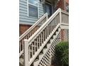 Exterior stairway with lattice and railing leading to a blue house with brick facade at 1186 Ridenour Blvd # 5, Kennesaw, GA 30152