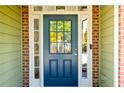 A welcoming front door with sidelights and transom window, set in a brick and siding facade at 5424 Landsdowne Ct, Cumming, GA 30041