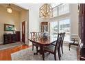 Formal dining room with a modern light fixture, neutral rug, and plenty of natural light at 5832 Sloane St, Douglasville, GA 30135
