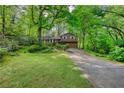 Picturesque view of a home with mature trees and a spacious driveway at 2520 Overlook Ne Way, Atlanta, GA 30345