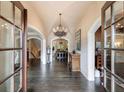 Grand foyer with dark hardwood floors, arched doorways, and a decorative chandelier at 3250 Twisted Branches Ln, Marietta, GA 30068