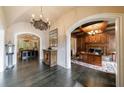 Elegant foyer featuring dark hardwood floors, arched entrances, and access to a wood paneled office at 3250 Twisted Branches Ln, Marietta, GA 30068
