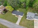 Aerial view of a well-maintained property showcasing the home, yard, and surrounding neighborhood at 3451 Birchwood Trl, Snellville, GA 30078
