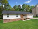Charming single-story home features a well-manicured lawn, brick accents, and a welcoming front porch at 3451 Birchwood Trl, Snellville, GA 30078