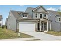 Stylish two-story home with a two-car garage, covered entryway, and a well-maintained front lawn at 3698 Annsbury Ct, Lilburn, GA 30047