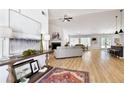 Bright, open-concept living room featuring hardwood floors, vaulted ceilings, and stylish decor at 7375 Cavaletti Cir, Cumming, GA 30040