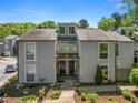 Charming townhome featuring a symmetrical facade, double front doors, and well-maintained landscaping at 1009 Riverbend Club Se Dr, Atlanta, GA 30339