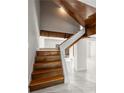Unique staircase with wood treads and a white and natural wood frame, leading to bright, open spaces at 1009 Riverbend Club Se Dr, Atlanta, GA 30339