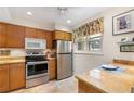 Kitchen features stainless appliances, granite counters, and a window at 5180 Chemin De Vie, Atlanta, GA 30342