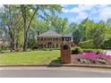 Beautiful brick home with lush lawn, flowering plants, and a classic mailbox at 5790 Heards Forest Dr, Atlanta, GA 30328