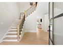 Bright foyer with hardwood floors, staircase, and an open view to the living room at 5790 Heards Forest Dr, Atlanta, GA 30328