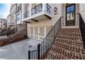 Brick stairs lead to a brown front door with a black metal railing at 255 Briscoe Way # 5, Alpharetta, GA 30009