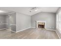 Spacious living room with light grey walls and a stone fireplace at 402 Leslie Ct, Mcdonough, GA 30253