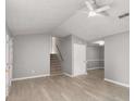 Neutral living room with lots of space, modern floors, ceiling fan, and staircase at 402 Leslie Ct, Mcdonough, GA 30253