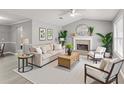 Cozy living room featuring neutral furniture, fireplace, and plant accents at 402 Leslie Ct, Mcdonough, GA 30253