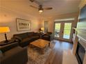 Cozy living room with hardwood floors, comfortable seating, fireplace, and access to a private balcony at 4130 Overland Dr, Roswell, GA 30075