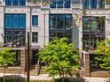 Charming townhome featuring a brick facade, outdoor seating area, and beautifully manicured landscaping at 1059 Abington Ct, Brookhaven, GA 30319
