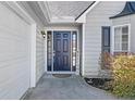 Inviting front entrance of this home, featuring a classic black door, sidelights, and a 'welcome' sign at 1325 Richland Creek Ct, Sugar Hill, GA 30518