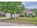 Beautiful home with manicured lawn, mature tree, and neutral exterior at 4719 Score Ct, Snellville, GA 30039