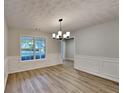 Bright dining room featuring modern lighting, and ample natural light at 132 Garden Manor Ct, Loganville, GA 30052