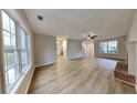Open living area with neutral walls, new floors, and a brick fireplace at 132 Garden Manor Ct, Loganville, GA 30052